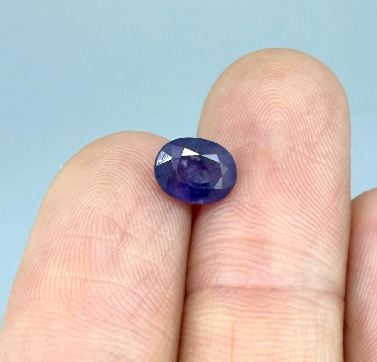 Oval-cut rich purple sapphire from Thailand, natural faceted gemstone suitable for fine jewelry.