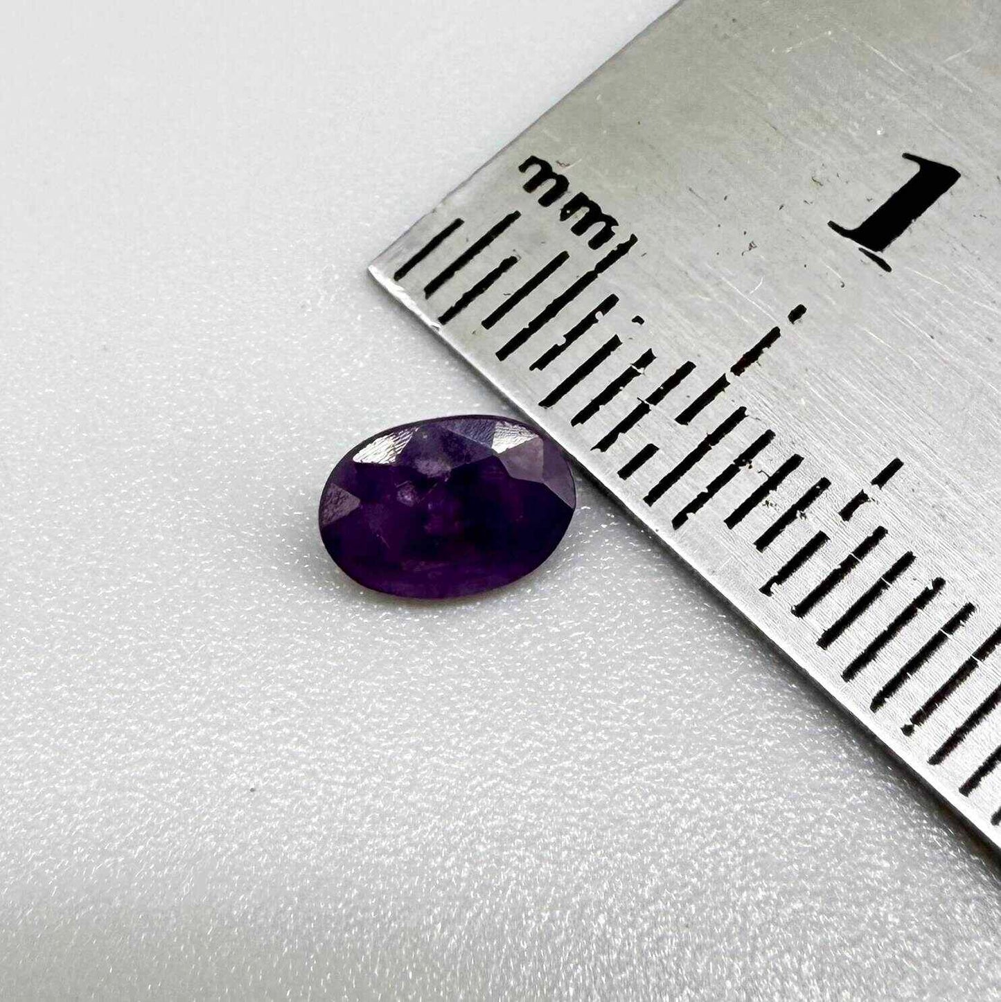 Oval-cut rich purple sapphire from Thailand, natural faceted gemstone suitable for fine jewelry.