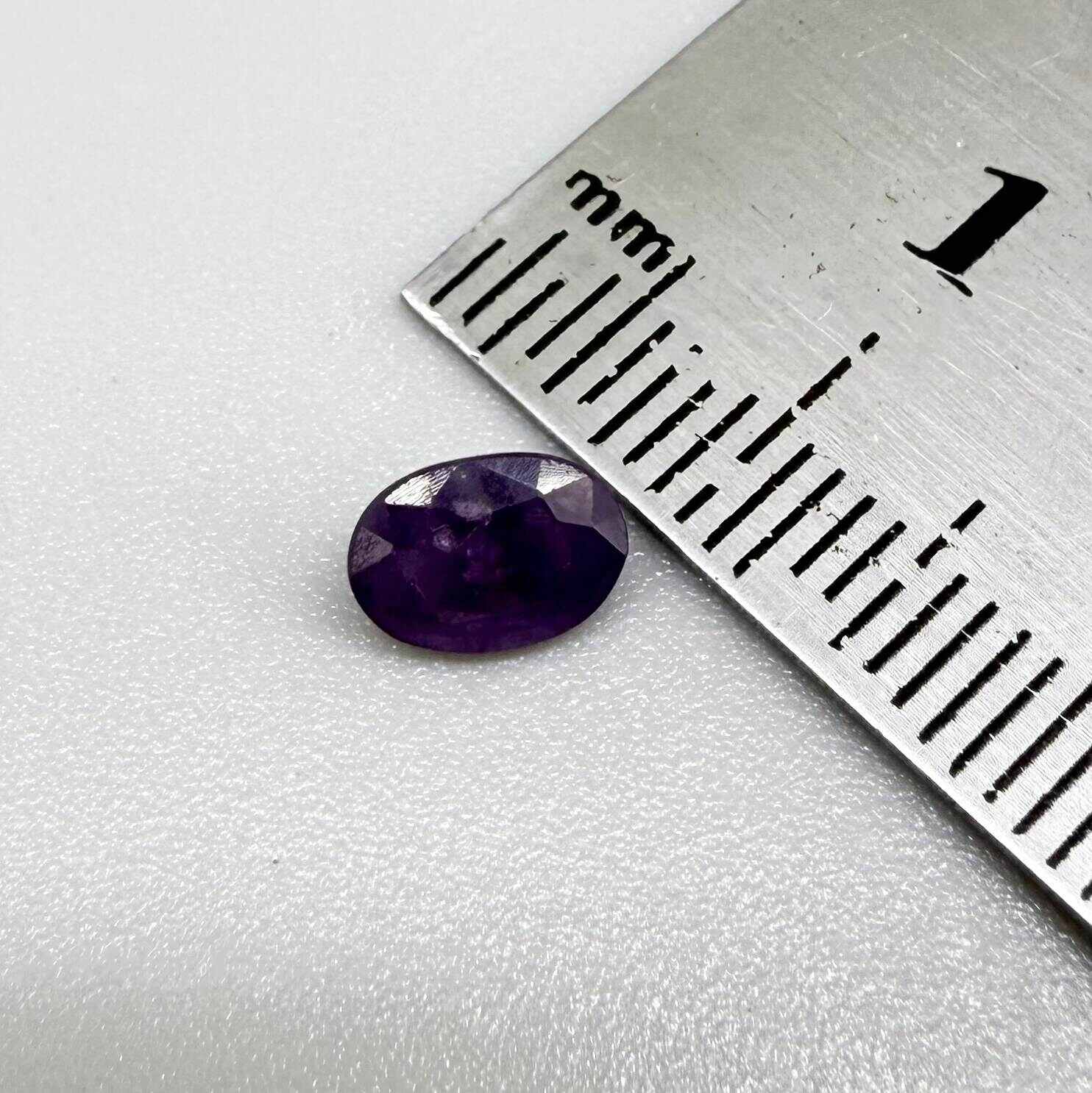 Oval-cut rich purple sapphire from Thailand, natural faceted gemstone suitable for fine jewelry.