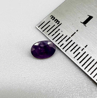 Oval-cut rich purple sapphire from Thailand, natural faceted gemstone suitable for fine jewelry.