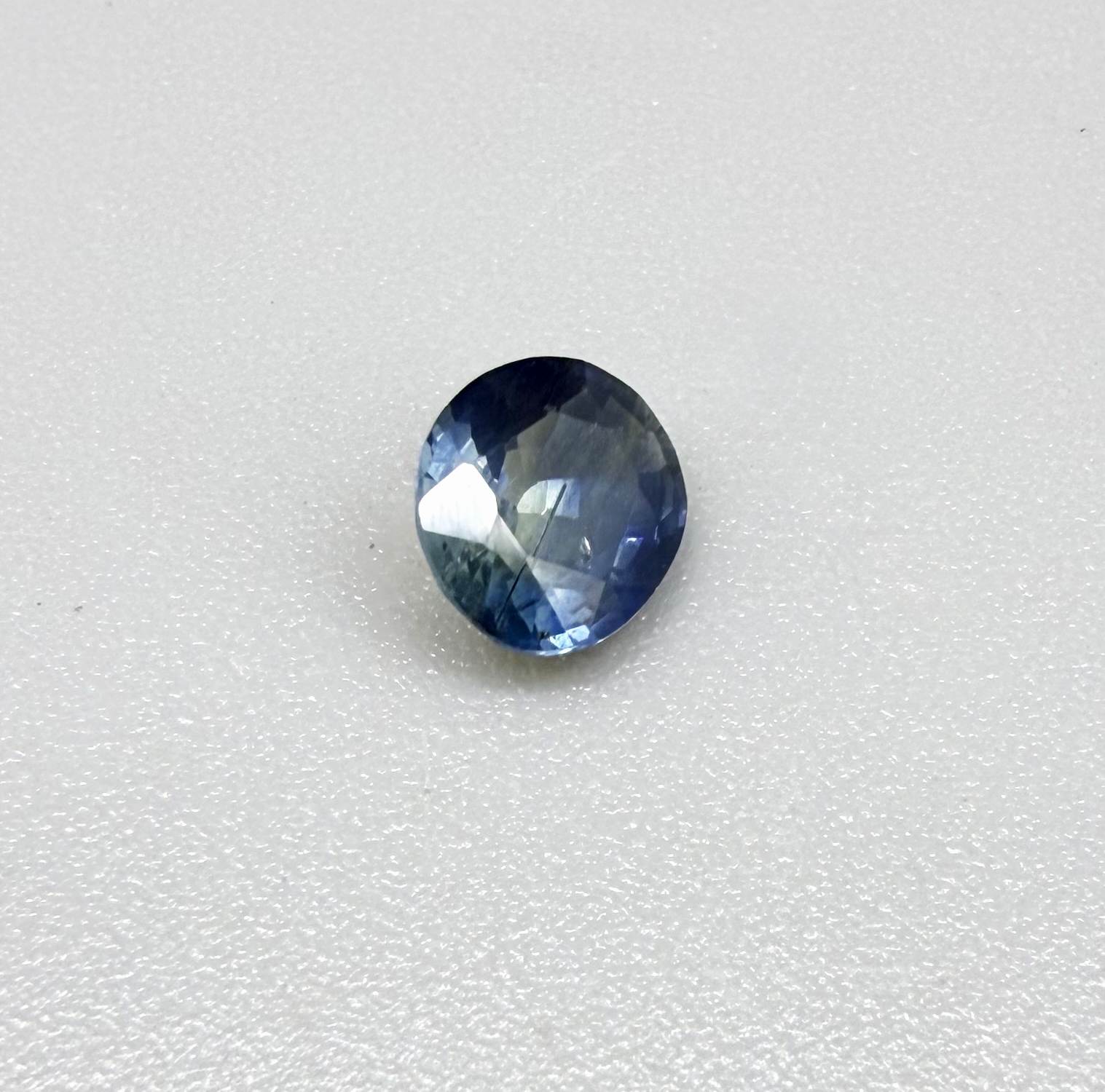Oval cut light medium blue sapphire from Bangkaja, Thailand with natural color zoning and faceted brilliance.
