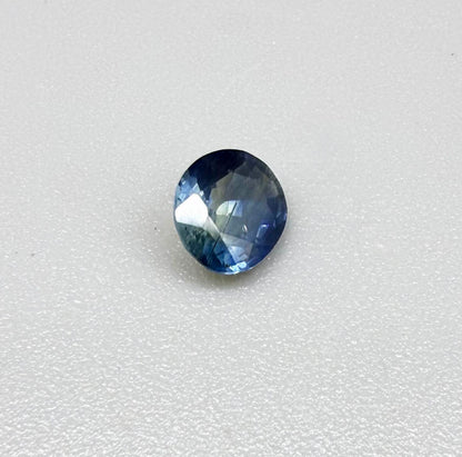 Oval cut light medium blue sapphire from Bangkaja, Thailand with natural color zoning and faceted brilliance.