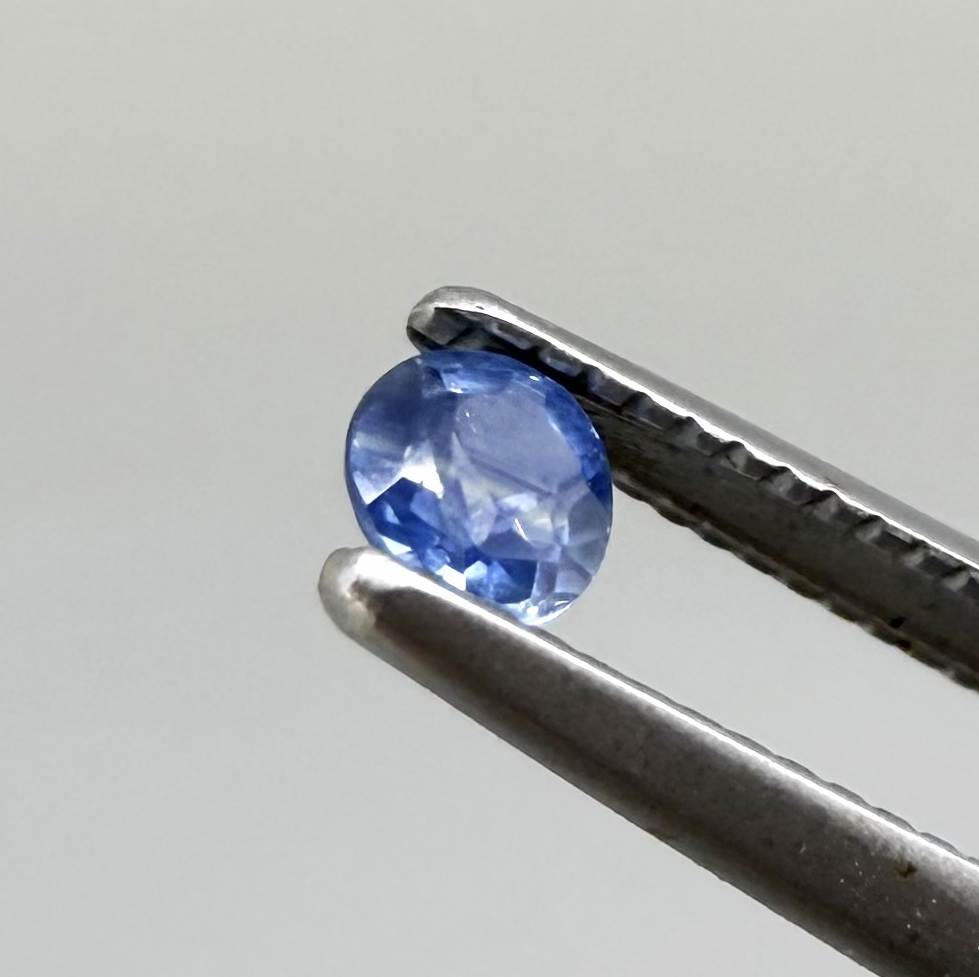 Round soft medium blue sapphire from Bangkaja, Thailand with natural color zoning and gentle silky blue tone.