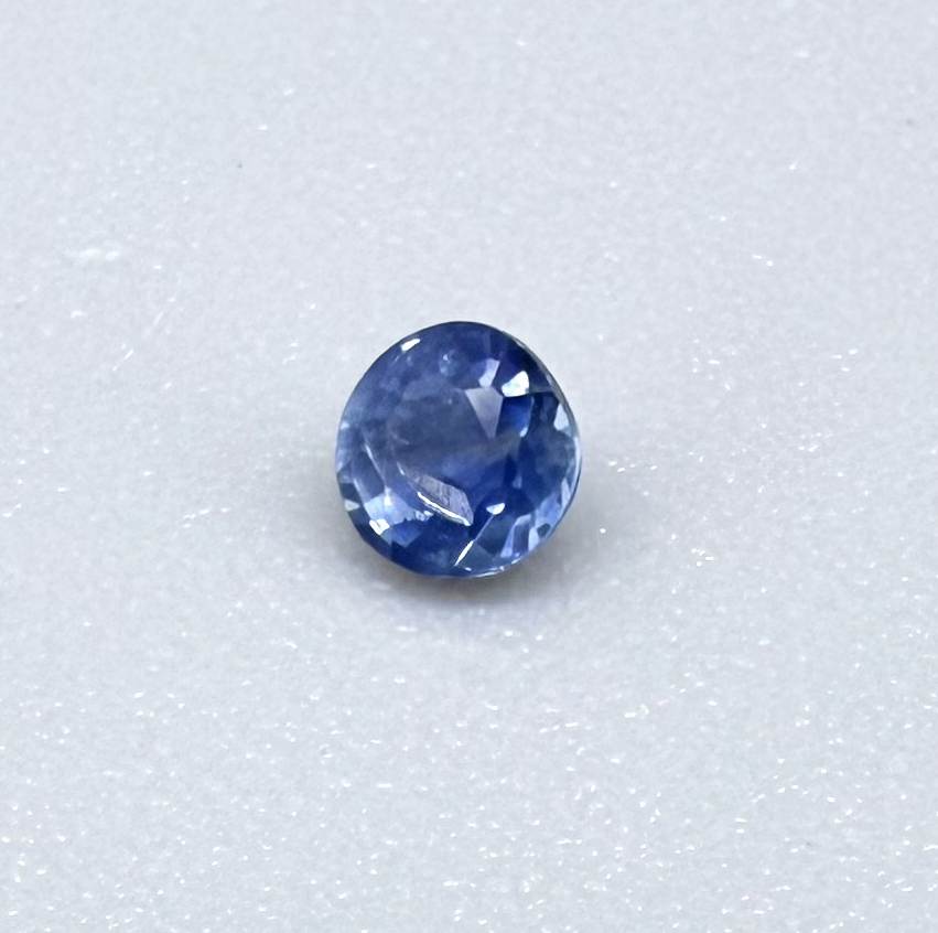 Round soft medium blue sapphire from Bangkaja, Thailand with natural color zoning and gentle silky blue tone.