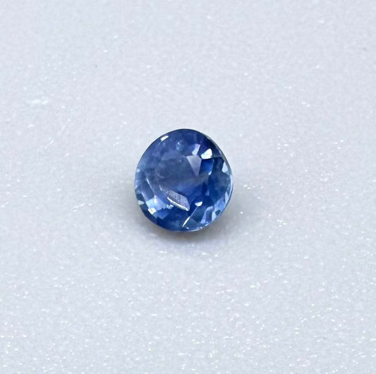 Round soft medium blue sapphire from Bangkaja, Thailand with natural color zoning and gentle silky blue tone.