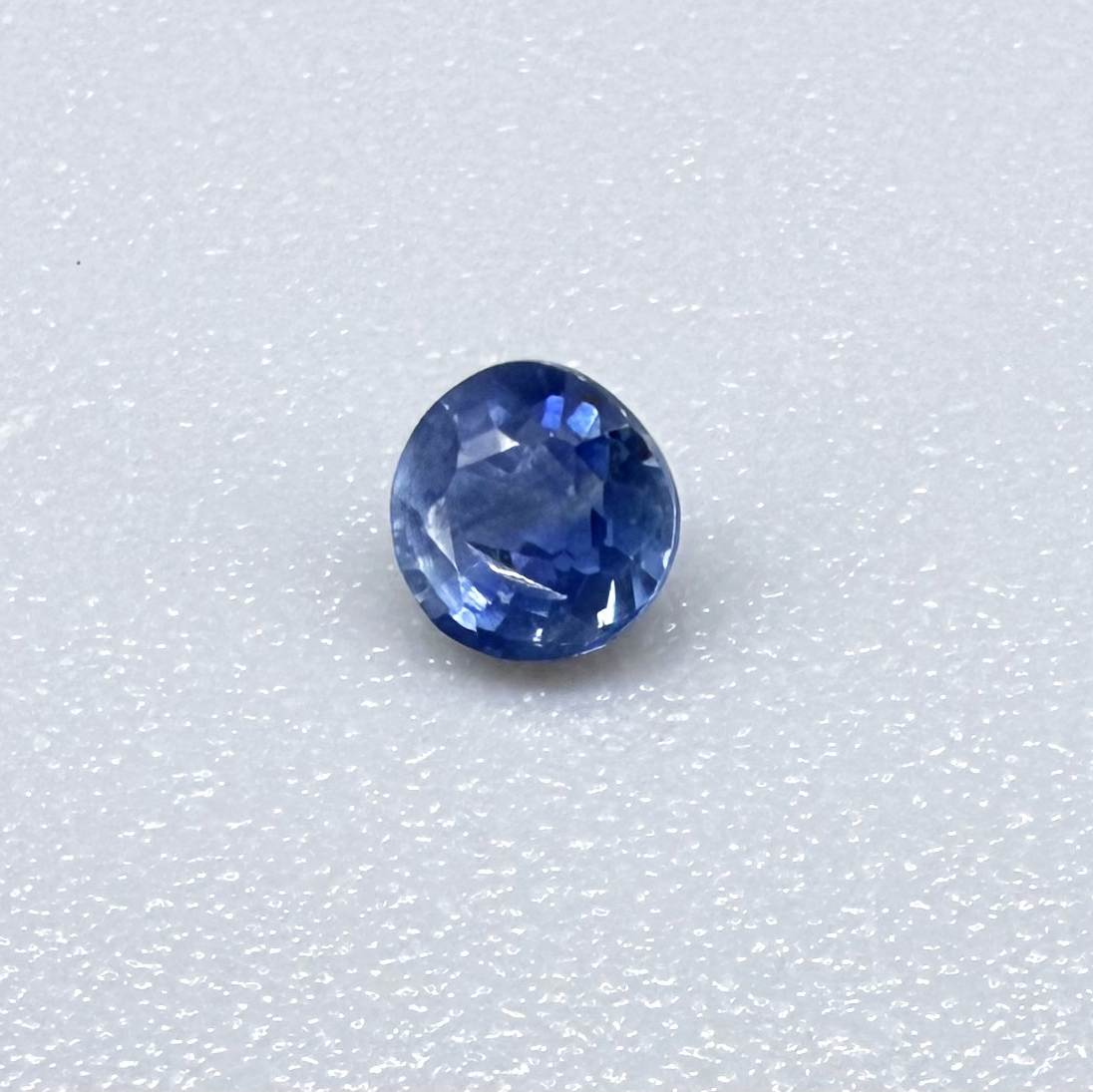 Round soft medium blue sapphire from Bangkaja, Thailand with natural color zoning and gentle silky blue tone.