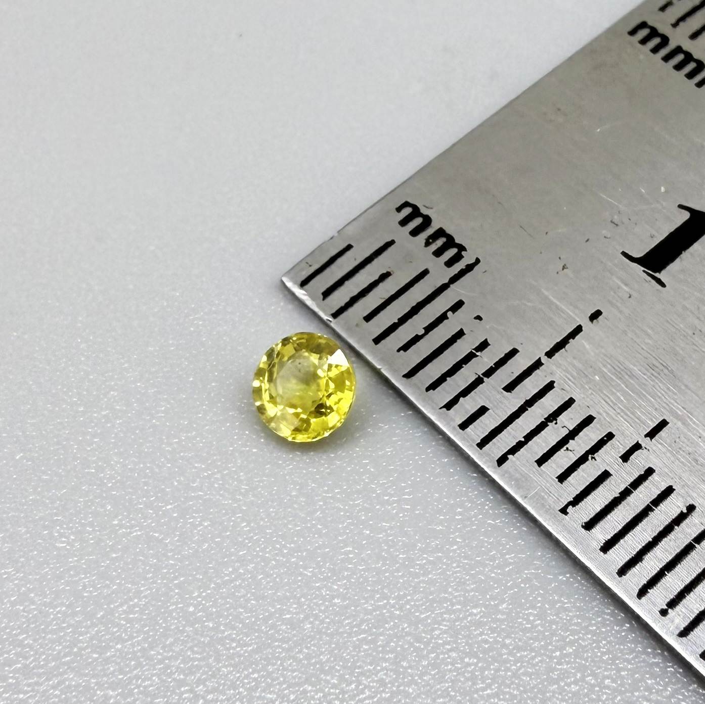 Round lemon yellow sapphire from Bangkaja, Thailand with vivid bright color and clean, lively brilliance.