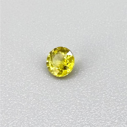 Round lemon yellow sapphire from Bangkaja, Thailand with vivid bright color and clean, lively brilliance.