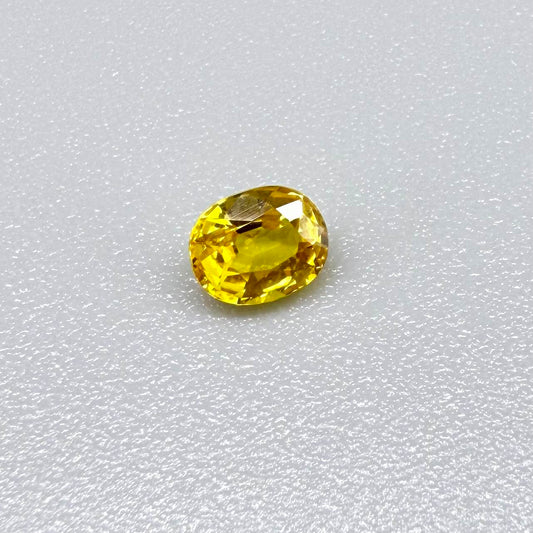 Oval golden yellow sapphire from Bangkaja, Thailand with vivid natural color and bright brilliance.