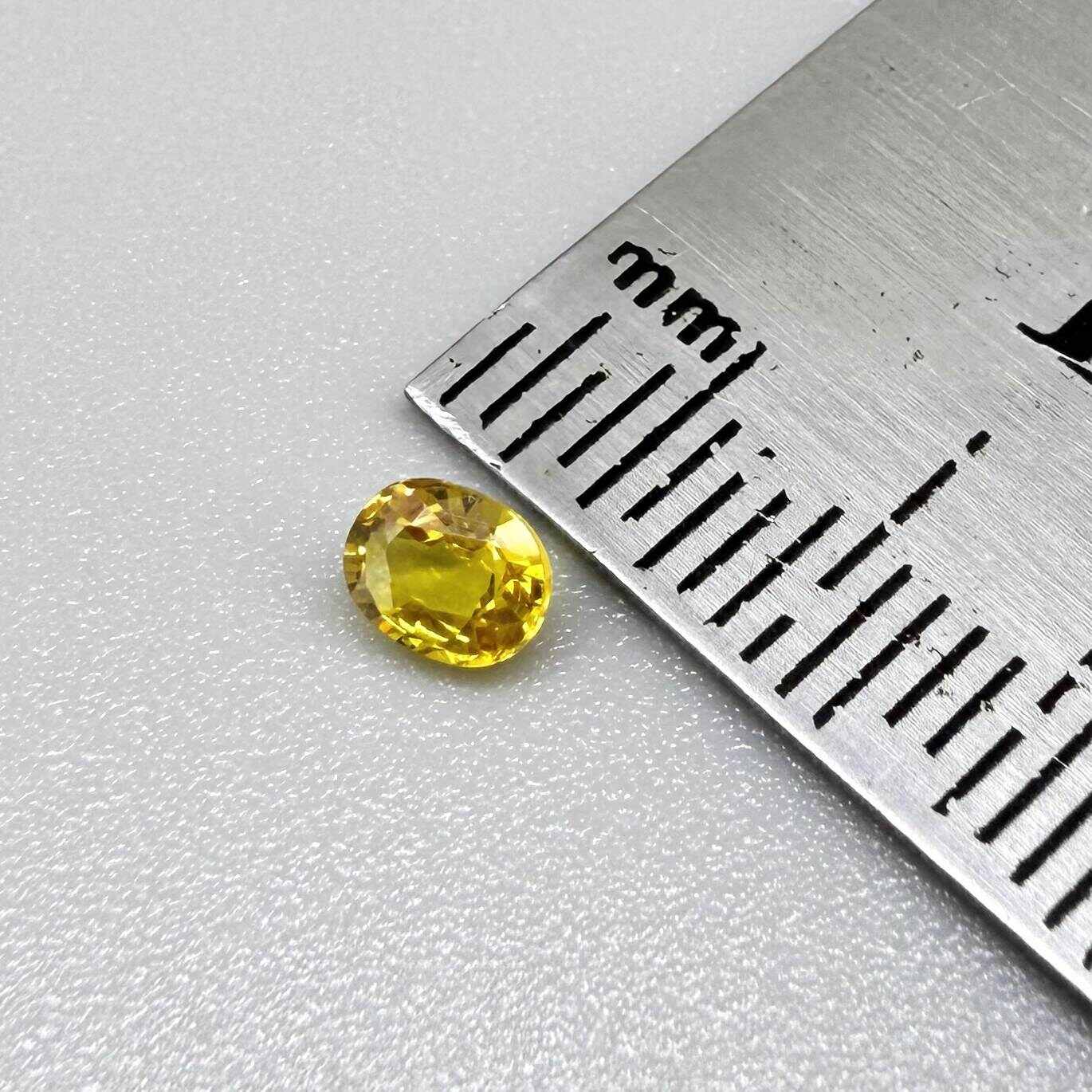 Oval golden yellow sapphire from Bangkaja, Thailand with vivid natural color and bright brilliance.