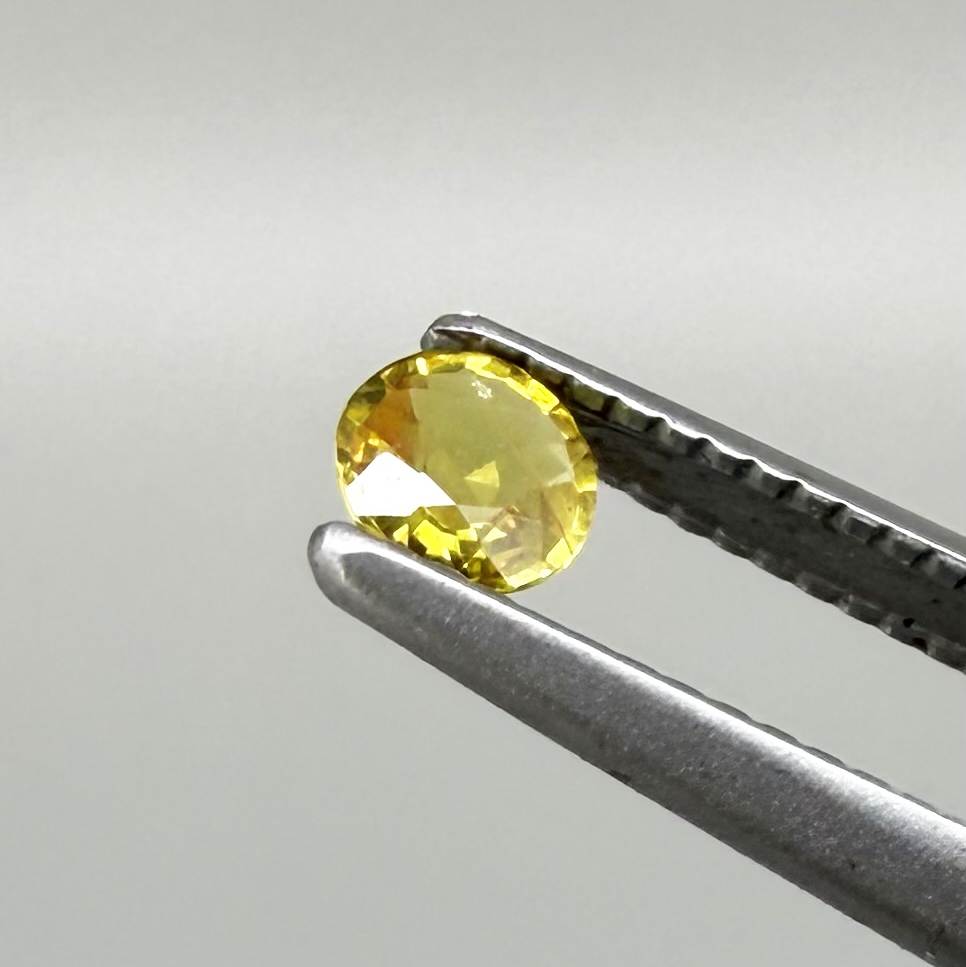 Round golden yellow sapphire from Bangkaja, Thailand with warm natural color and lively brilliance.