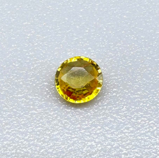 Round golden yellow sapphire from Bangkaja, Thailand with warm natural color and lively brilliance.