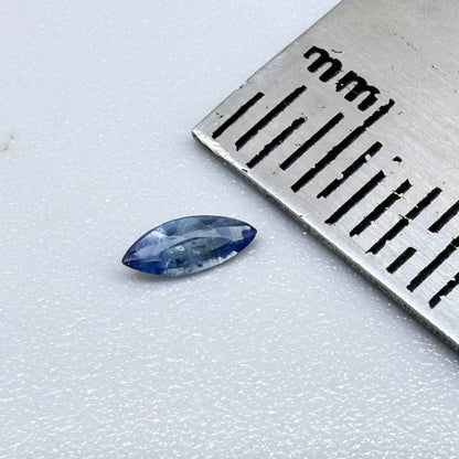 Marquise dark steel blue sapphire from Bangkaja, Thailand with natural zoning and deep blue tone.