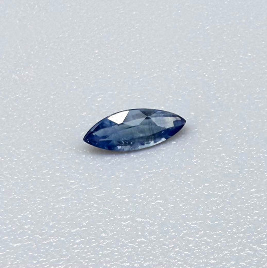 Marquise dark steel blue sapphire from Bangkaja, Thailand with natural zoning and deep blue tone.