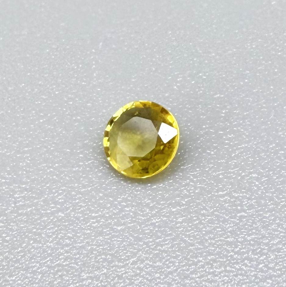 Round golden yellow sapphire from Bangkaja, Thailand with bright natural color and lively brilliance.