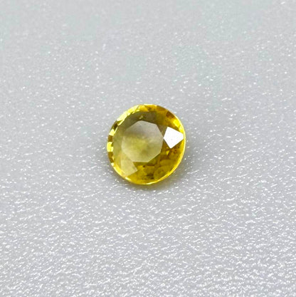 Round golden yellow sapphire from Bangkaja, Thailand with bright natural color and lively brilliance.