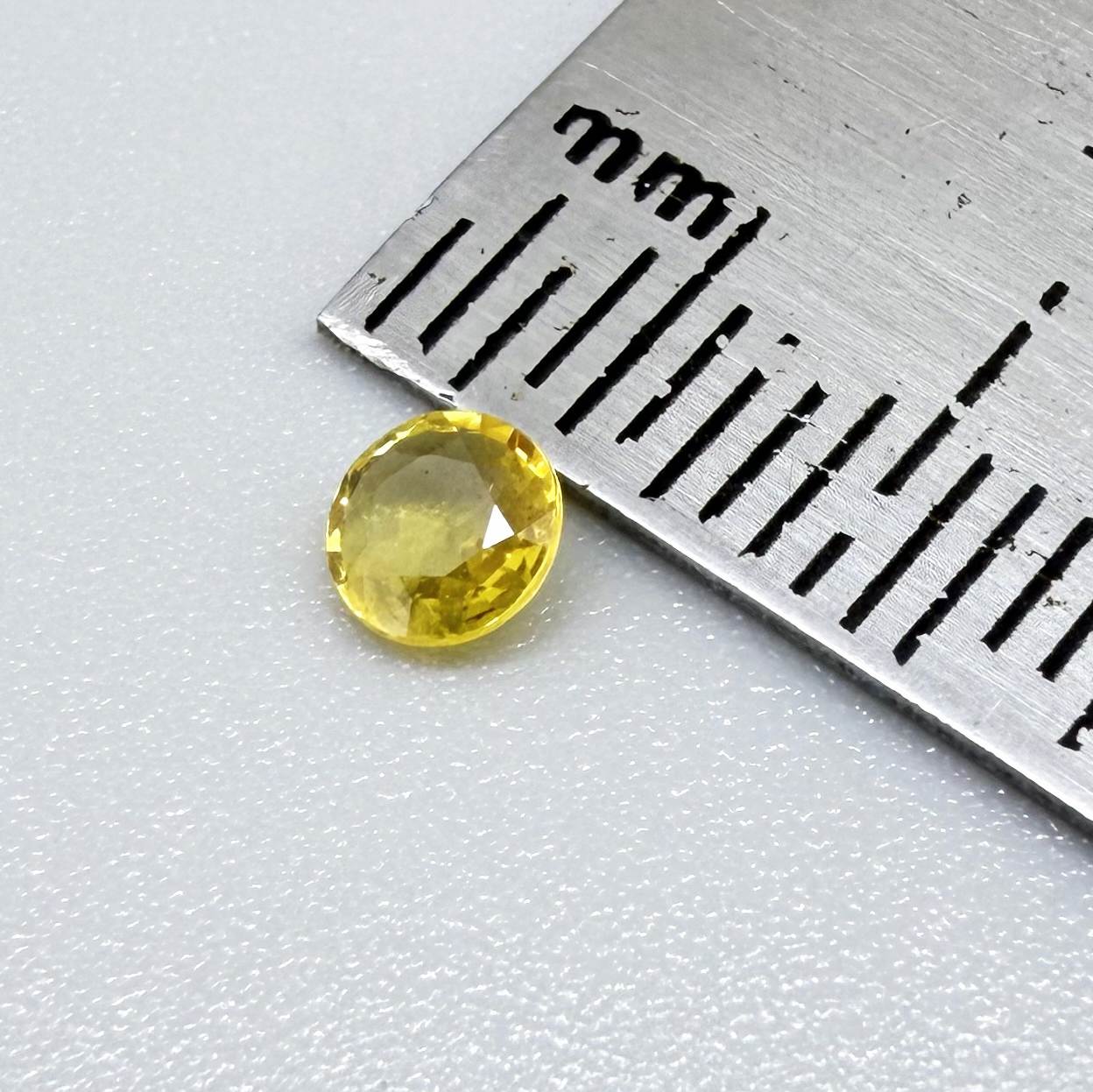 Round golden yellow sapphire from Bangkaja, Thailand with bright natural color and lively brilliance.