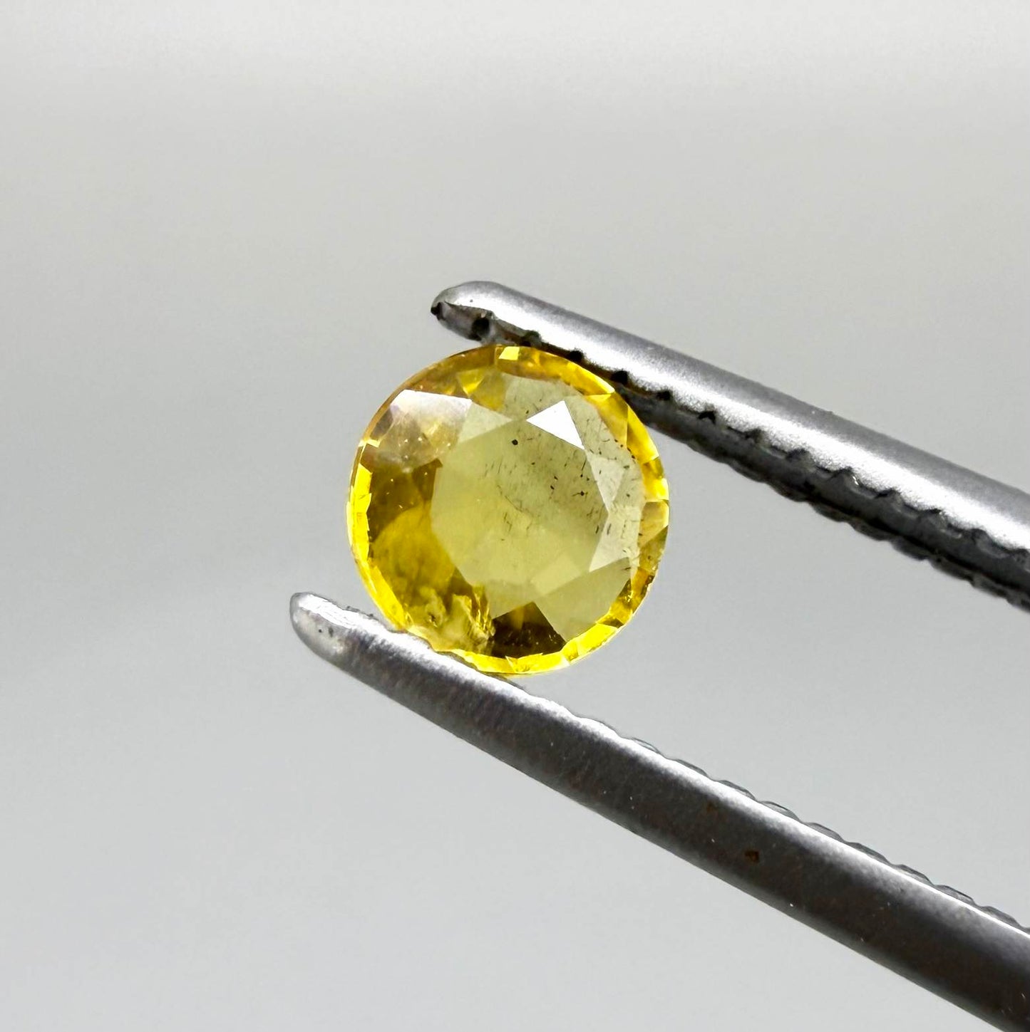 Round golden yellow sapphire from Bangkaja, Thailand with bright natural color and lively brilliance.
