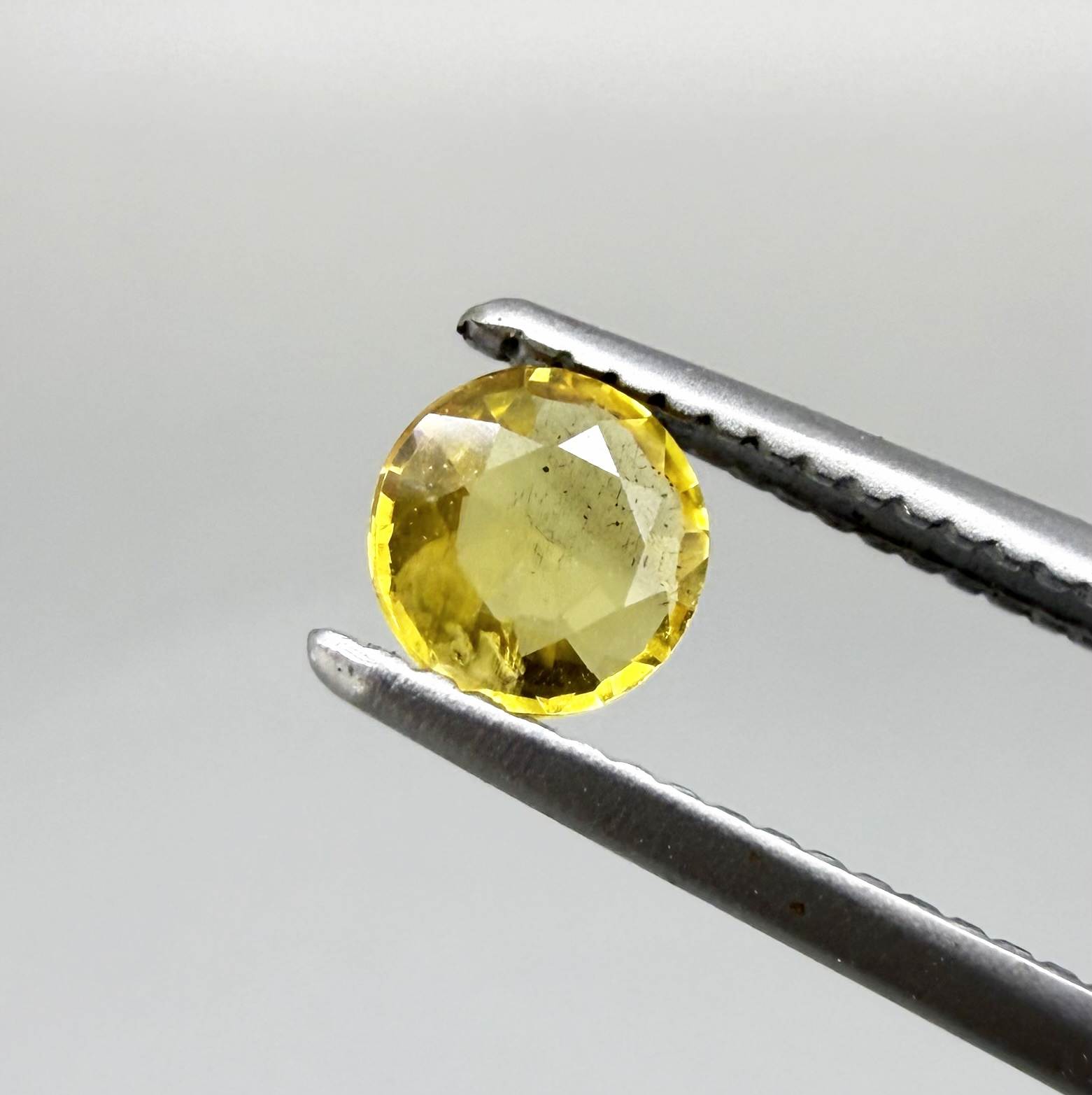 Round golden yellow sapphire from Bangkaja, Thailand with bright natural color and lively brilliance.