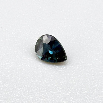Dark teal blue sapphire from Bangkaja, Thailand in pear cut with deep tone and subtle greenish blue undertone.