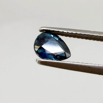 Dark teal blue sapphire from Bangkaja, Thailand in pear cut with deep tone and subtle greenish blue undertone.