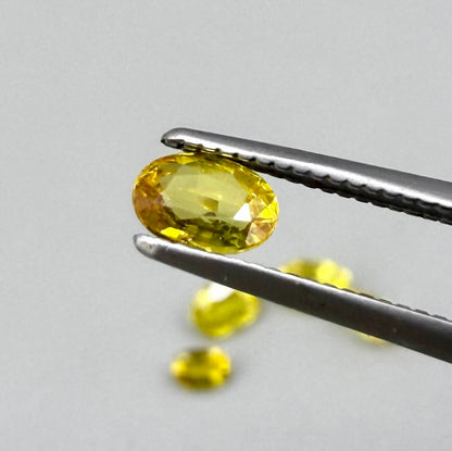 Yellow sapphire parcel in oval cuts from Bangkaja, Thailand showing lemon, golden and orangey tones with bright natural brilliance.