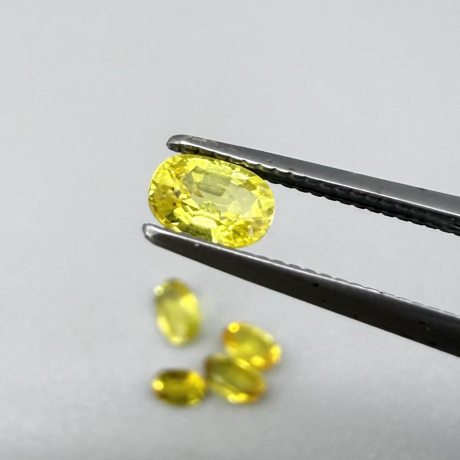 Yellow sapphire parcel in oval cuts from Bangkaja, Thailand showing lemon, golden and orangey tones with bright natural brilliance.