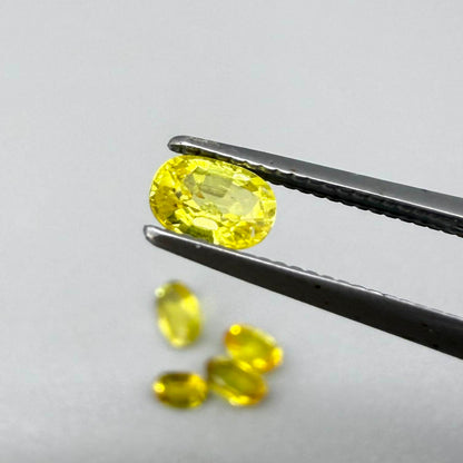 Yellow sapphire parcel in oval cuts from Bangkaja, Thailand showing lemon, golden and orangey tones with bright natural brilliance.