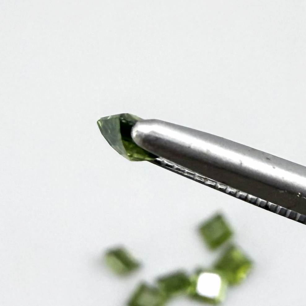 Green sapphire parcel in square cuts from Bangkaja, Thailand showing olive to yellowish-green tones with natural brilliance.