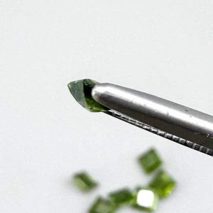 Green sapphire parcel in square cuts from Bangkaja, Thailand showing olive to yellowish-green tones with natural brilliance.
