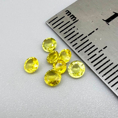Yellow sapphire parcel in oval and round cuts from Bangkaja, Thailand showing lemon to light golden tones with bright natural brilliance.