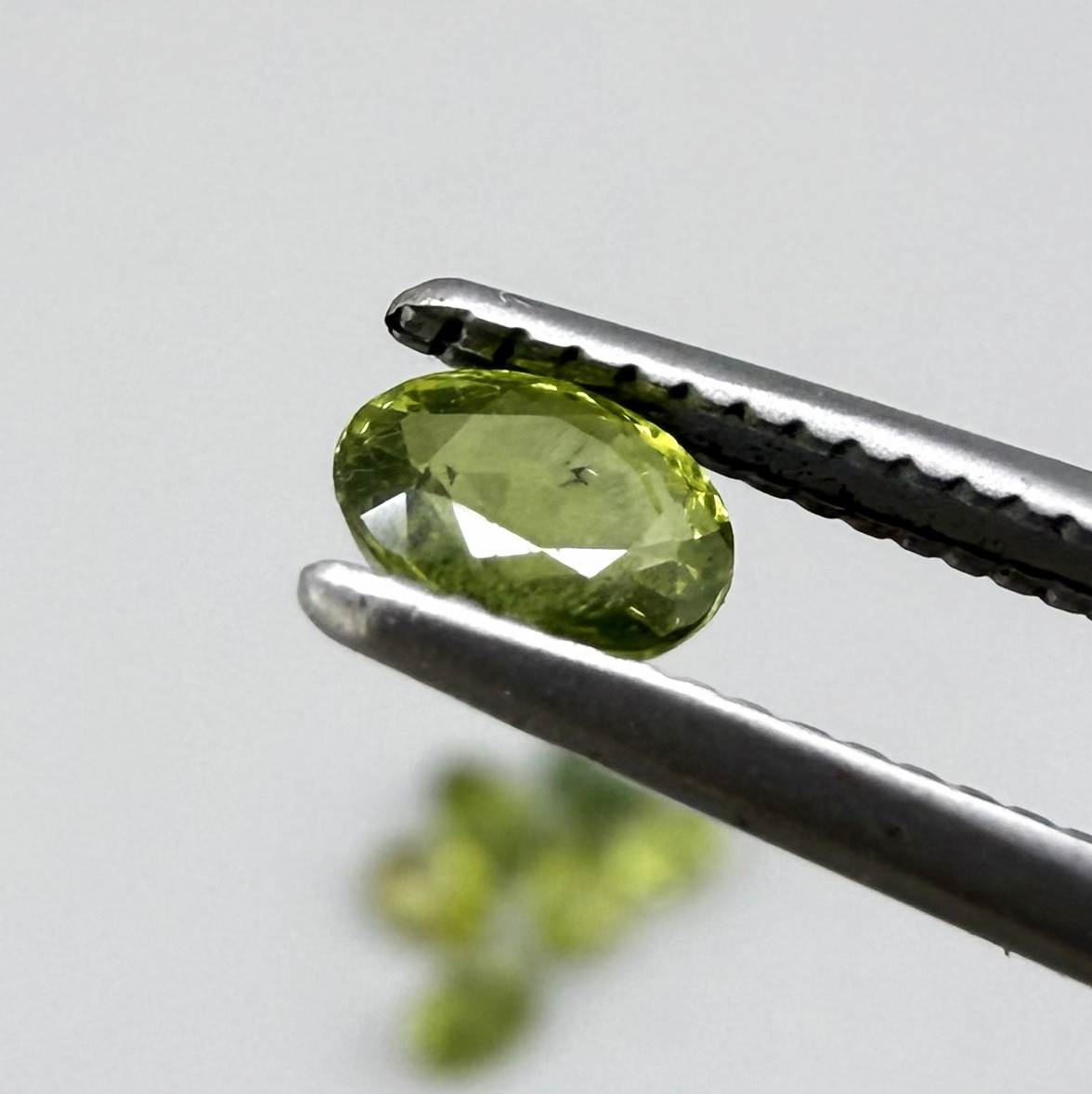 Green sapphire parcel in oval cuts from Bangkaja, Thailand showing yellowish-green to olive tones with natural brilliance.