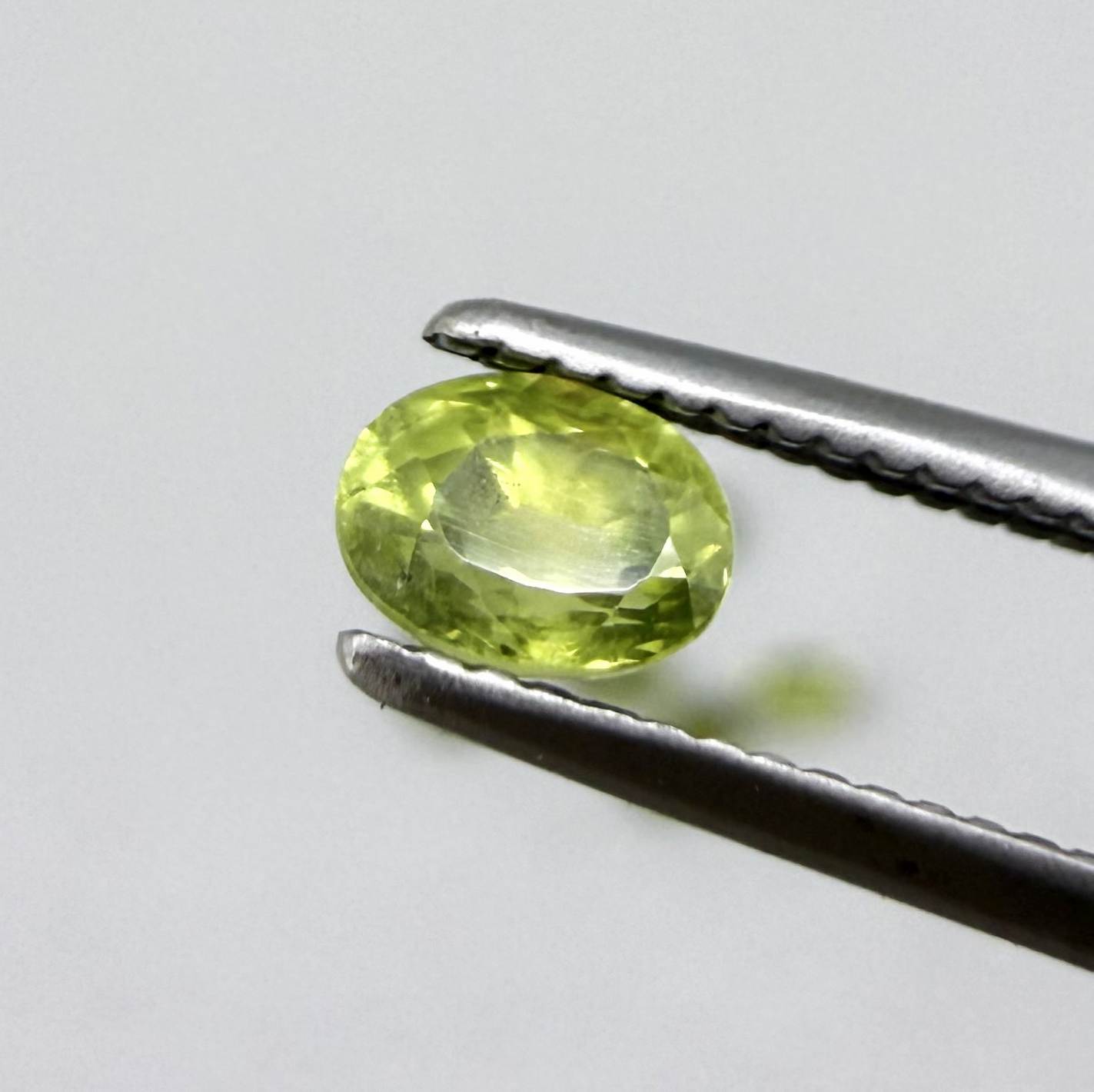 Green sapphire parcel in oval cuts from Bangkaja, Thailand showing yellowish-green to olive tones with natural brilliance.