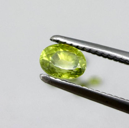Green sapphire parcel in oval cuts from Bangkaja, Thailand showing yellowish-green to olive tones with natural brilliance.