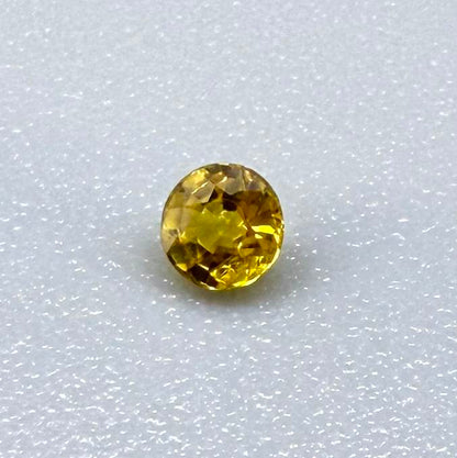 Round rich golden yellow sapphire from Bangkaja, Thailand with warm tone and strong natural brilliance.