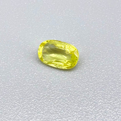 Cushion-cut lemon yellow sapphire from Bangkaja, Thailand with soft bright color and natural brilliance.