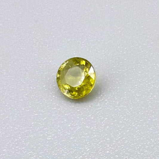 Round light lemon yellow sapphire from Bangkaja, Thailand with soft bright color and natural brilliance.