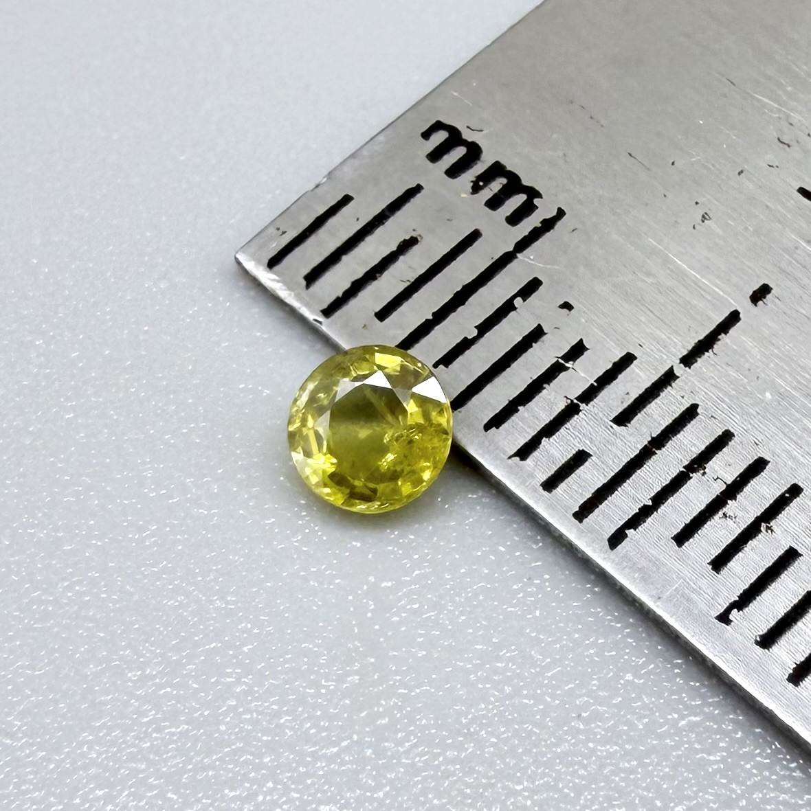 Round light lemon yellow sapphire from Bangkaja, Thailand with soft bright color and natural brilliance.