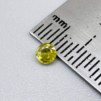 Round light lemon yellow sapphire from Bangkaja, Thailand with soft bright color and natural brilliance.