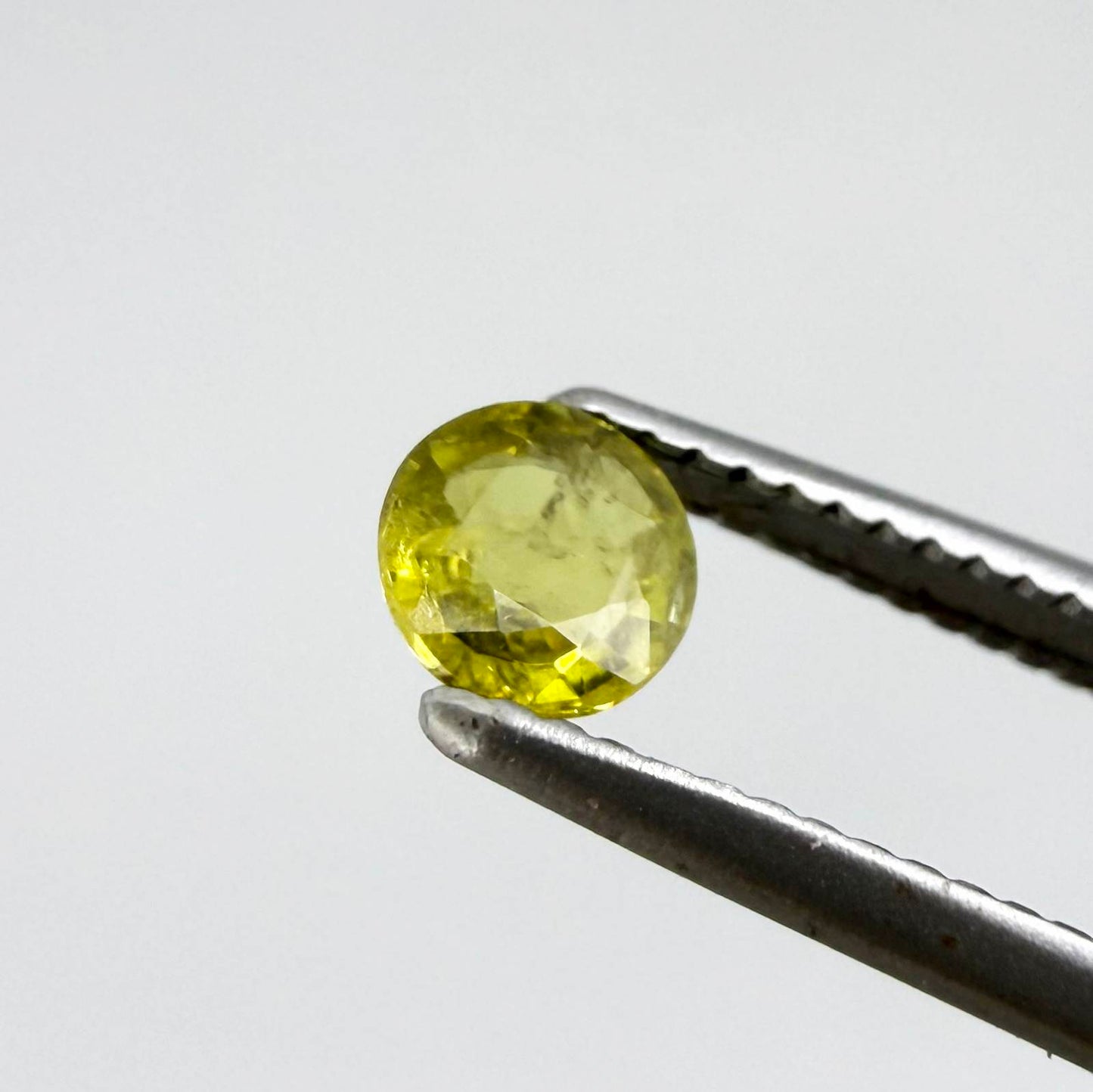 Round light lemon yellow sapphire from Bangkaja, Thailand with soft bright color and natural brilliance.