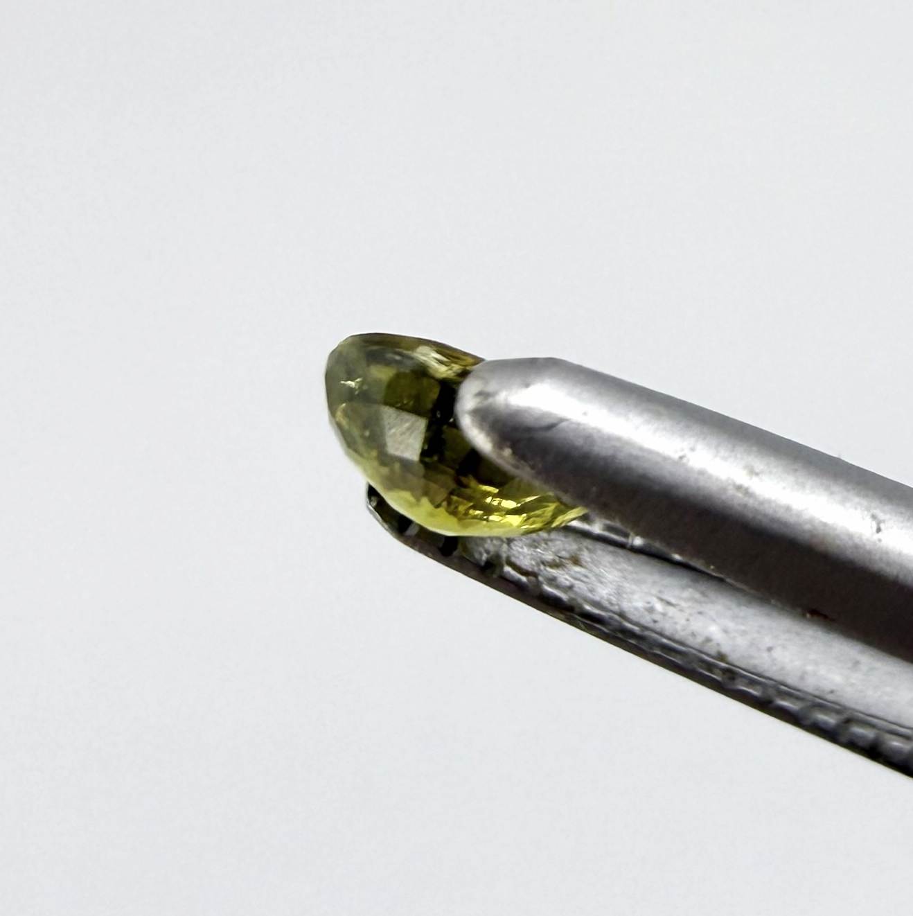 Round light lemon yellow sapphire from Bangkaja, Thailand with soft bright color and natural brilliance.