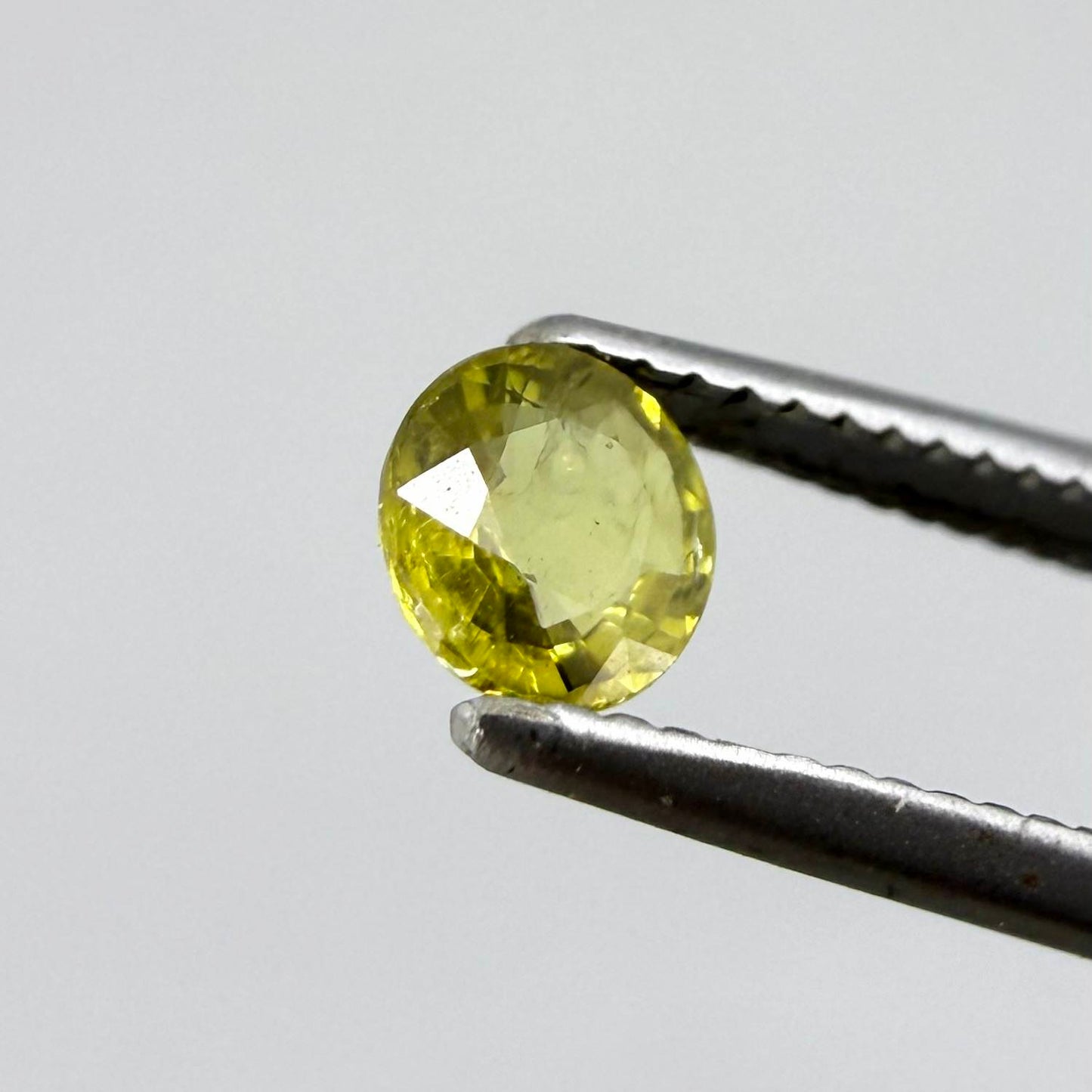 Round light lemon yellow sapphire from Bangkaja, Thailand with soft bright color and natural brilliance.