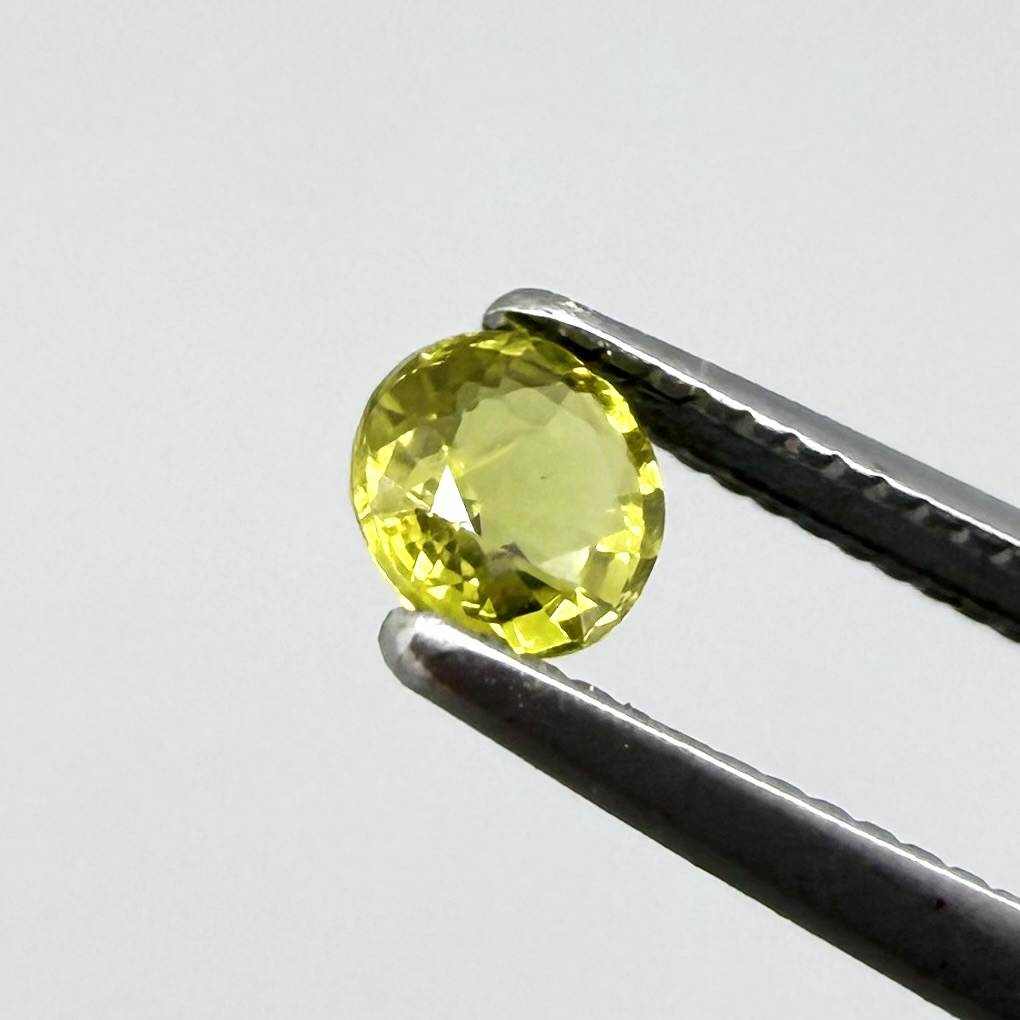 Round pale lemon yellow sapphire from Bangkaja, Thailand with soft luminous color and natural brilliance.