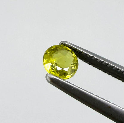 Round pale lemon yellow sapphire from Bangkaja, Thailand with soft luminous color and natural brilliance.