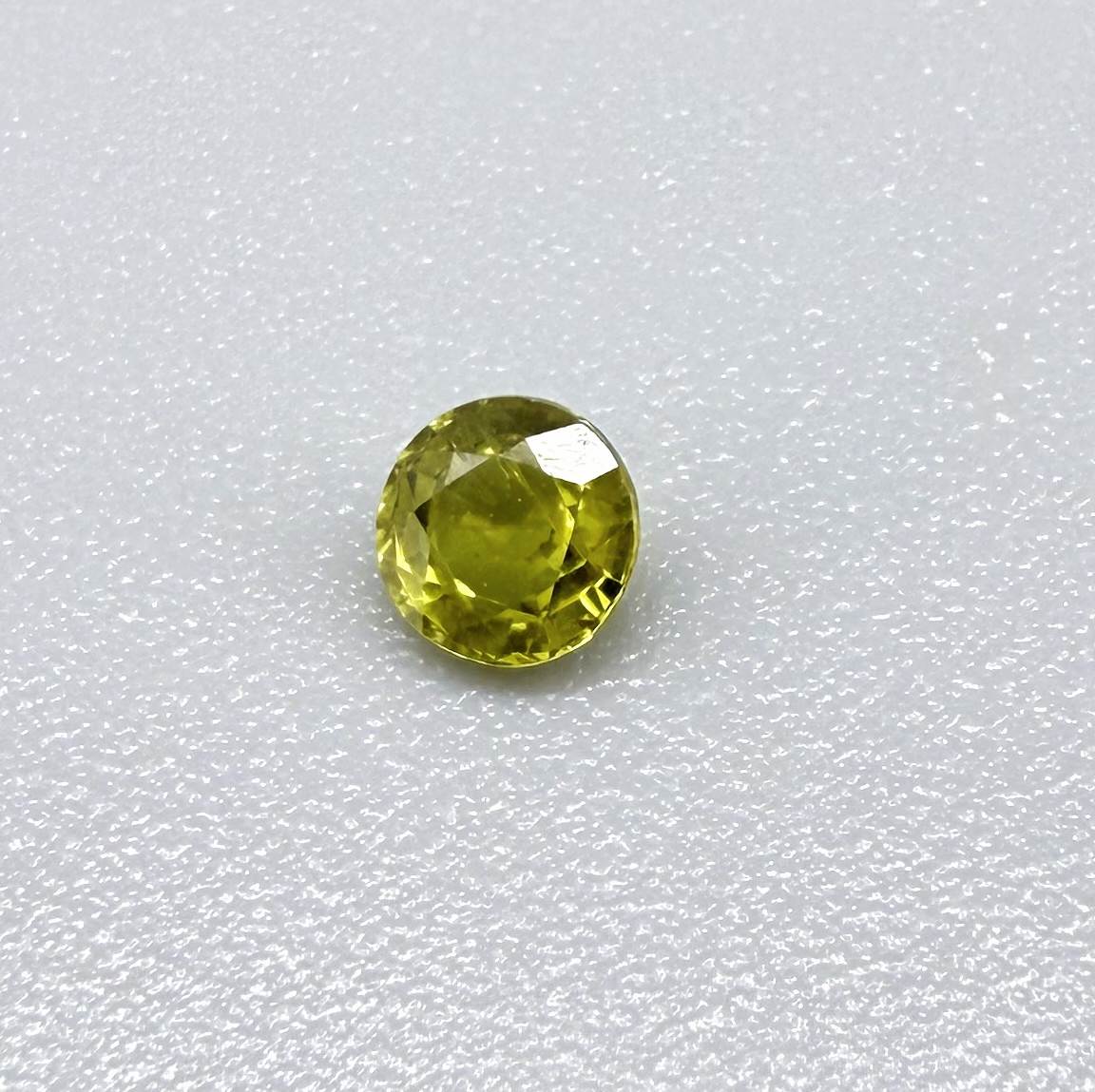 Round pale lemon yellow sapphire from Bangkaja, Thailand with soft luminous color and natural brilliance.