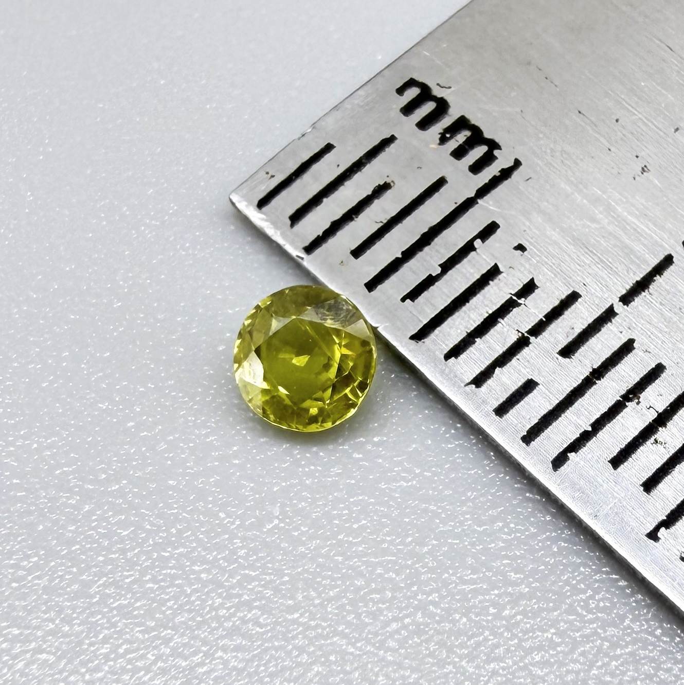 Round pale lemon yellow sapphire from Bangkaja, Thailand with soft luminous color and natural brilliance.