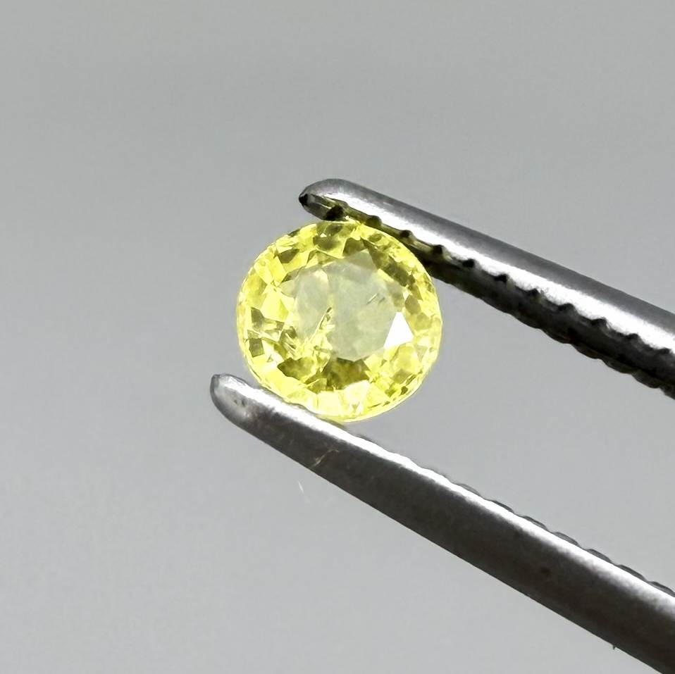 Round light lemon yellow sapphire from Bangkaja, Thailand with delicate bright color and clean natural brilliance.