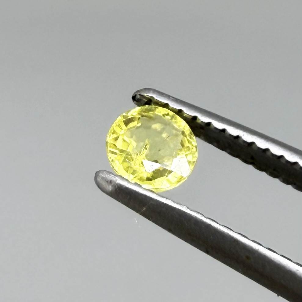 Round light lemon yellow sapphire from Bangkaja, Thailand with delicate bright color and clean natural brilliance.