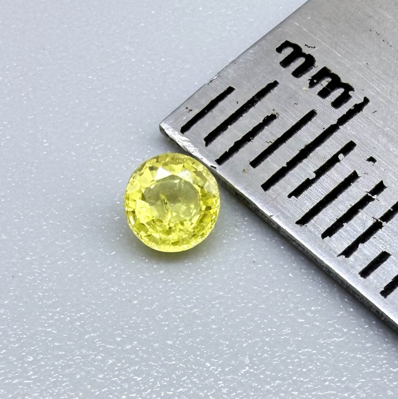 Round light lemon yellow sapphire from Bangkaja, Thailand with delicate bright color and clean natural brilliance.