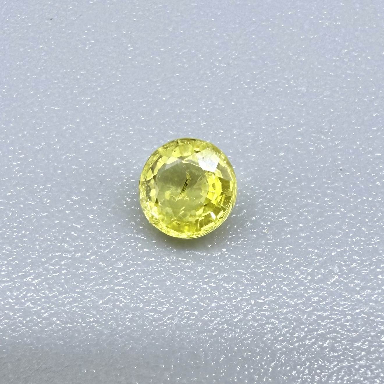 Round light lemon yellow sapphire from Bangkaja, Thailand with delicate bright color and clean natural brilliance.